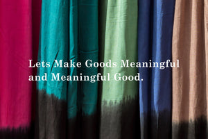 Lets make Goods Meaningful and Meaningful Good placed over brightly colored dip dyed fabric