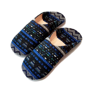 Blue Jay Moroccan Babouche Slipper by Socco Designs. Handmade in Morocco. These Moroccan babouche slippers are handcrafted from natural leather coated with custom printed fabrics to make them distinctively modern. The soft leather will fit like a glove when your first slide them on. Features a cushioned insole to provide more perfect comfort as you wander around the house. Color blue. 100% natural leather sole.