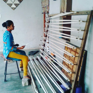 Artisan handweaving on a wooden loom