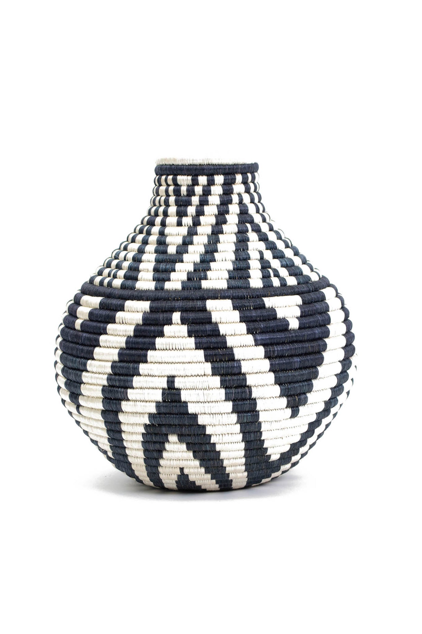 Black Mbao Vase by All Across Africa. Handwoven in Rwanda. Intricately crafted with timeless tradition, this carefully dyed sisal fiber and sweet grass vase makes a stunning statement piece. Color Black and White. 100% sisal.