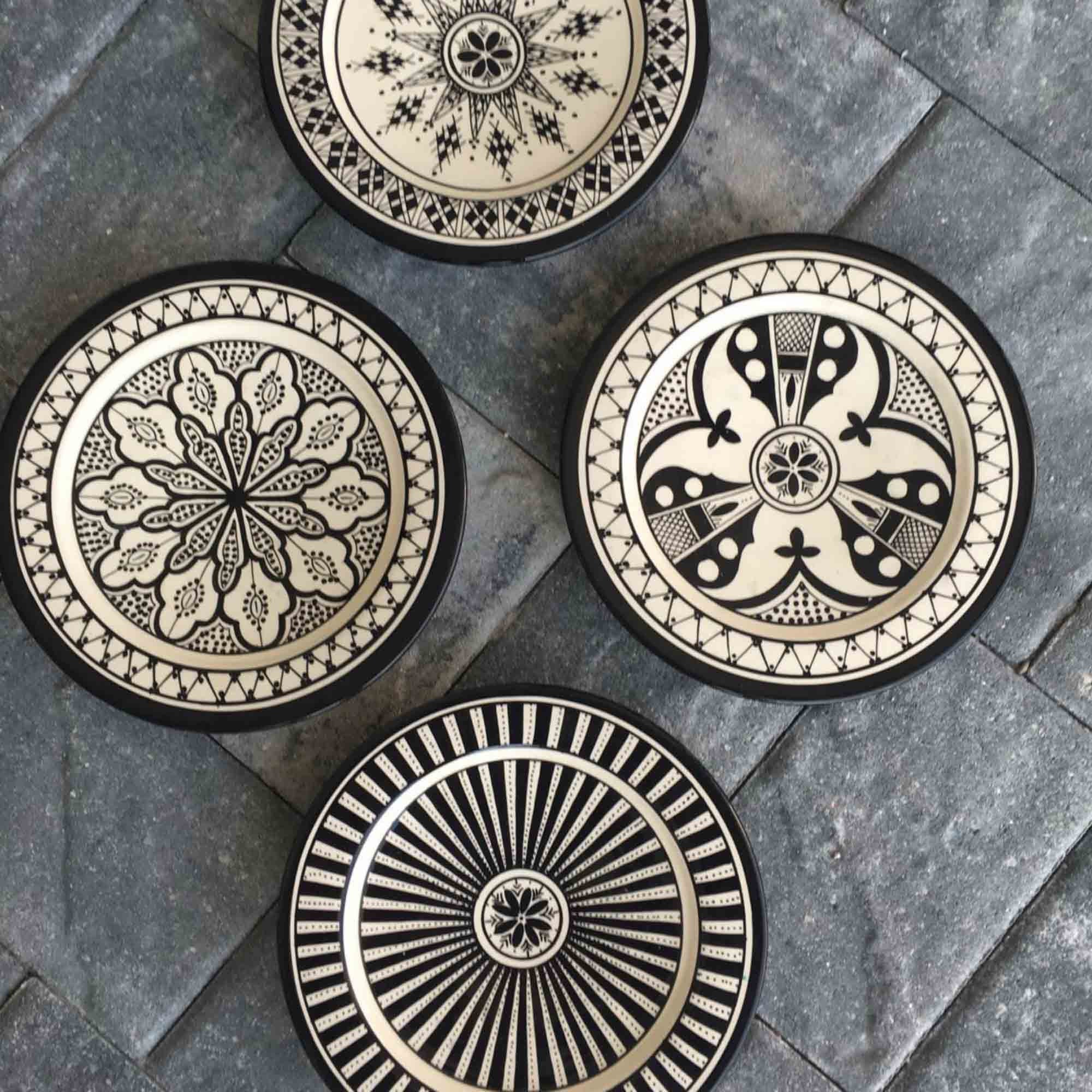 Handmade in Morocco Safi Plates from Atelier Boemia. Four different and beautifully hand-painted plates (can also be used as wall hanging-holes for wire to be inserted on backside). Available in dinner and appetizer sizes. Handmade in Safi, Morocco. Dishwasher and microwave safe. Measurements Dinner: 25 cm (10") diameter .Appetizer: 17 cm (7") diameter.