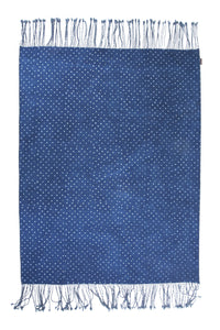 Neel Embroidered Indigo Dot Throw by Anhad Craft. Hand printed in India. This handmade throw is passionately painted, patched, and stitched together. Hand block printed reversible throw with embroidered details and heathered fringe edges. Color blue. 100% cotton.