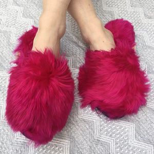 Ariana Bohling Suri Slipper in Fuchsia. Slide on baby alpaca slipper made from cruelty free alpaca fur by artisans in Peru. Open toe slipper with Alpaca upper and lining. Micro suede sole. Color hot pink. 100% baby alpaca. Sizes Small Medium Large.