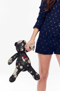 Mayi Mascot from Diego Binetti. Handmade denim mascot by Binetti Home with bleached detailing and embroidered heart. This giant teddybear makes the perfect ethically-crafted gift. Black and White Denim. Measurments Height Sitting Position: 13.5"