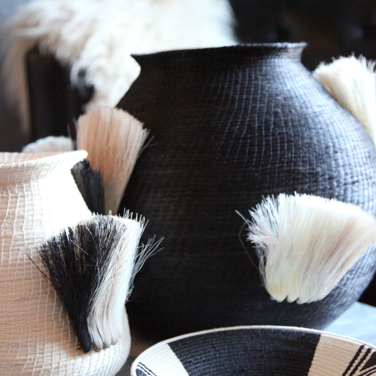 Fanned Out Large Bulbous Vase in Black/White by Charlie Sprout. Handmade in Swaziland, these unique and bold decorative accents support female artisans and are bold additions to any room. Swazi baskets are the most labor intensive of all the African baskets, taking between 30-80 hours to make each piece.