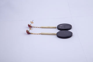 Accompany Exclusive Soko Black Horn Nairobi Drop Earring. Tiered pendulum drop earring. Hand dyed bone bead at post. Cast brass tube bead. Brass chain. Hand carved horn medallion. Post setting for pierced ears. 2.5 inch drop from post. Color black clay gold. 100% brass hardware. Dyed bone and ankole horn. One size.