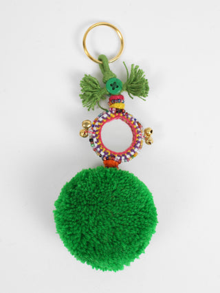 The Pom Pom Mirror Keyring by Bohemia Design is a bright wool pom pom embellished with colorful decorated mirrors, beads and bells -- handmade in India by artisans. This eye-catching pom pom keyring adds a fun twist to your everyday routine. Available in Navy Jade Green Purple Red Yellow Orange Pink Ivory Grey Azure Black  100% Wool Pom Pom Measurements 6" L