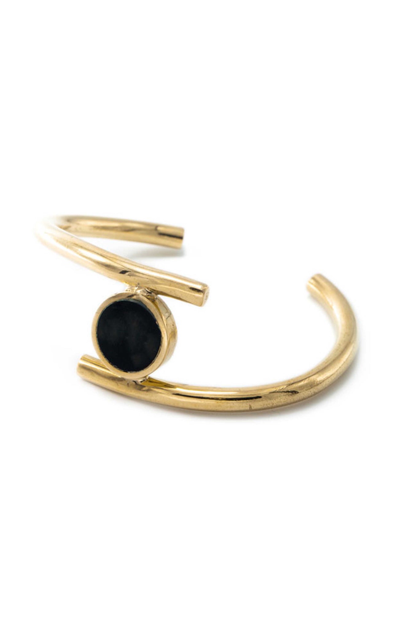 Soko Spring 2018 Lucine Statement Cuff Bracelet. Cast brass statement cuff with carved circular horn medallion accent. Handcrafted in Kenya using traditional artisan techniques. Color gold black. Recycled polished brass. Hand carved horn. Adjustable size.