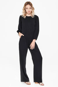 Sitting Pretty Fall 2018 Lila Panelled Jumpsuit in Black. Flared leg jumpsuit featuring cropped tapered sleeves and a slight drop waist. Round neckline with front and back yoke. Front zip closure. Gathered shoulder with wide cuff. Slant pockets. Regular fit. Made in South Africa. Color black. 100% rayon twill. Sizes small medium large.