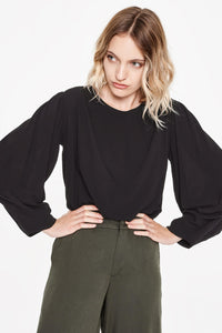 Sitting Pretty Fall 2018 Sofia Loose Tapered Blouse in Black. Long sleeved tapered blouse featuring a round neckline and curved hem. Relaxed fit. Made in South Africa. Color black. 100% rayon crepe. Sizes small medium large.