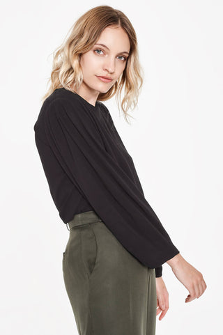 Sitting Pretty Fall 2018 Sofia Loose Tapered Blouse in Black. Long sleeved tapered blouse featuring a round neckline and curved hem. Relaxed fit. Made in South Africa. Color black. 100% rayon crepe. Sizes small medium large.