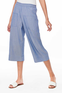 Sitting Pretty Spring 2018 Ellen Culottes in Denim. Loose fitting cotton chambray culotte pant. Wide leg with elastic waistband. Front patch pockets. Cropped pant. Small measures 31.5 inches from waist to hem. No side seam. Unlined. Color denim. 100% cotton. Sizes Small Medium Large.