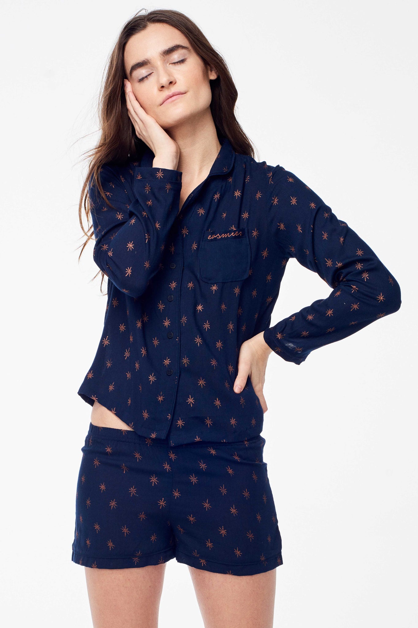 Accompany Exclusive Sitting Pretty Holiday 2017 Painted Stars PJ Set in Navy and Rose Gold. Printed cotton PJ set of 2. Long sleeved pajama style button up top with piping. Rounded collar. Front patch pocket with rose gold embroidery. Shorts with elastic wast and piping at hem. All over block printed rose gold star print. Unlined. Comfortable fit. Color Navy Blue and Rose Gold. 100% rayon. Sizes Small Medium Large.