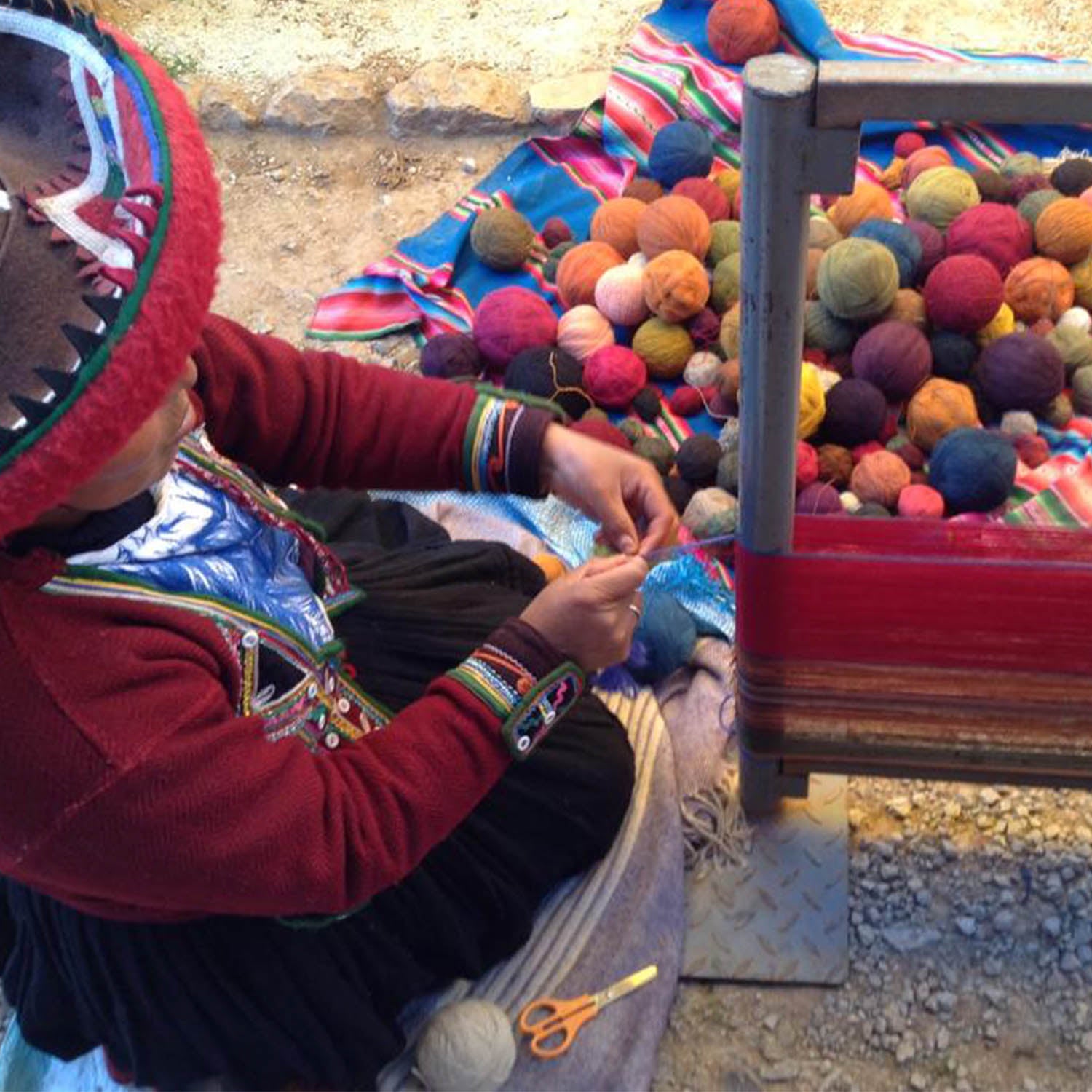 Artisan weaving an alpaca blanket