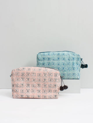 Bohemia Design Eye Print Cosmetic Case. Rectangular gusseted cosmetic bag made from lightweight cotton and finished with tonal pom pom detailing on the zipper. Block printed with evil eye pattern. 10 inches by 6 inches. 4 inch gusset. Colors Blush Duck Blue. 100% Cotton Canvas with Waterproof Lining. One size.