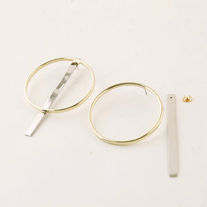 Accompany Exclusive Soko Compass Earring. Jacket hoop earring. Cast brass hoop. Chrome plated silver bar jacket. 2 inch diameter hoop. 3 inch drop from post. Post setting for pierced ears. Color gold silver. Brass, chrome plating. One size.